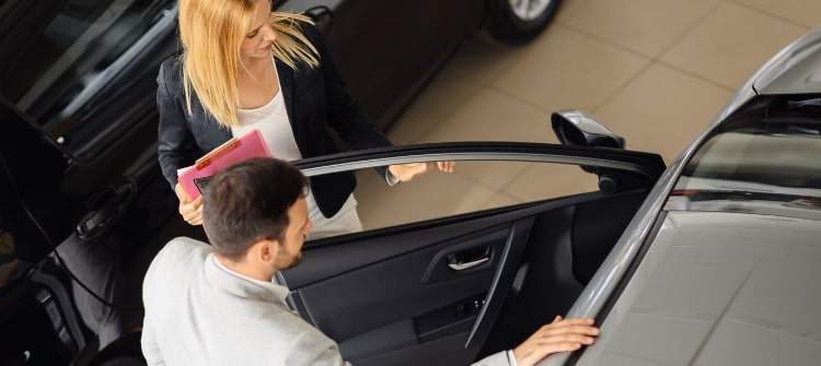 Man shopping for a new car during an economic downturn.