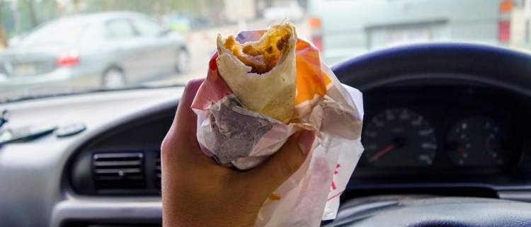 Eating a snack in a modern car.