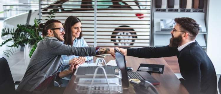 Self-employed individual reviewing car financing options at a dealership