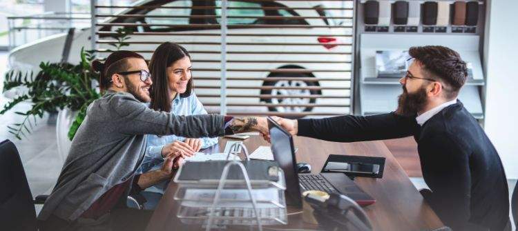 Self-employed individual reviewing car financing options at a dealership